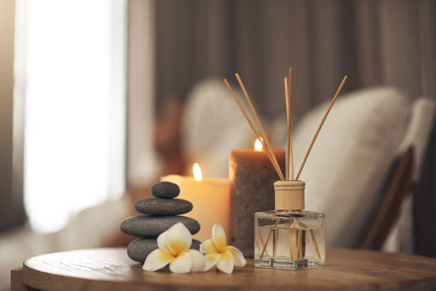 Spa ambiance with candles, stones and reed diffuser